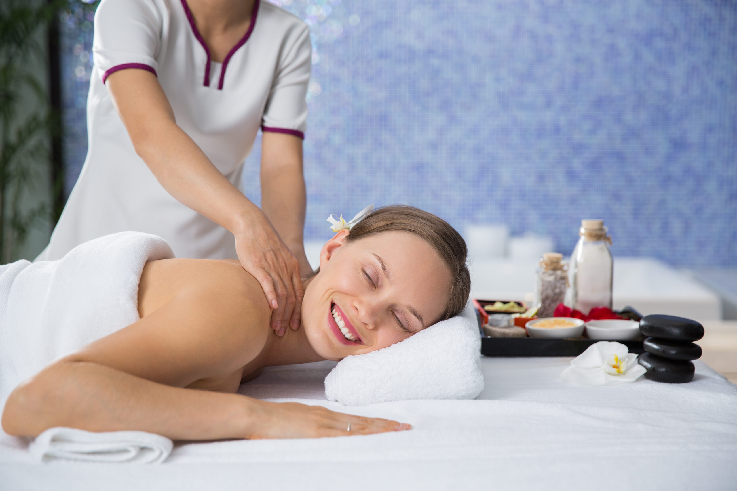 Happy Young Woman Getting Relaxing Massage in Spa